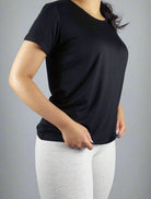 Woman wearing a black crew neck t shirt 