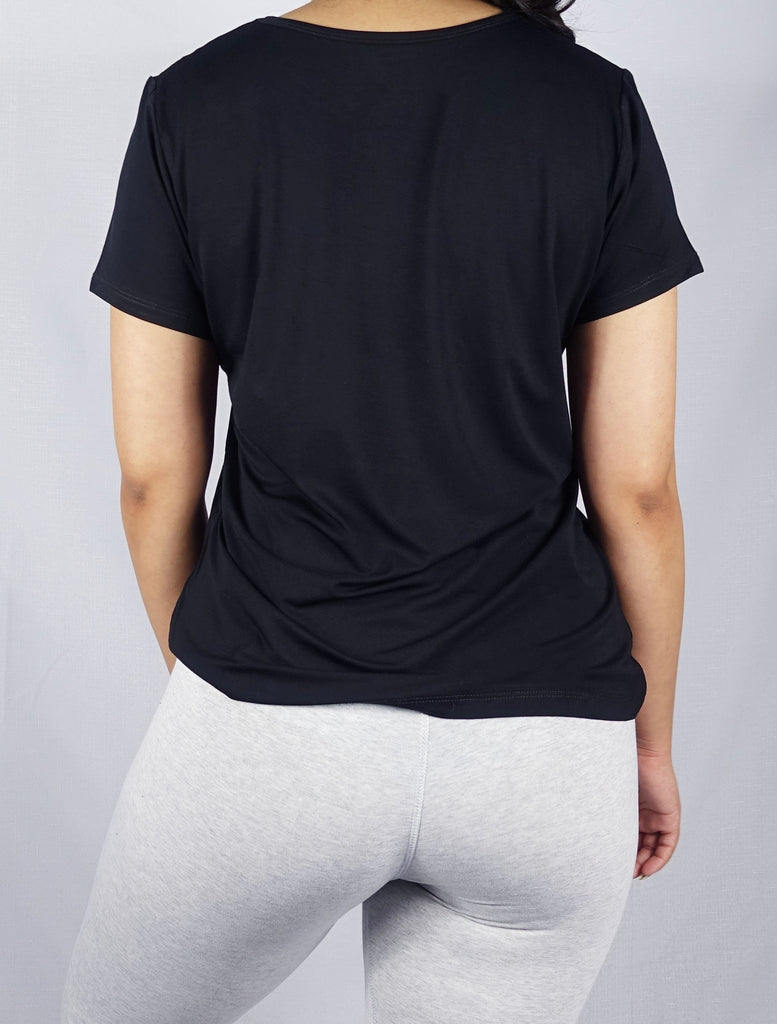 Back view of a black crew neck tee shirt on a  woman