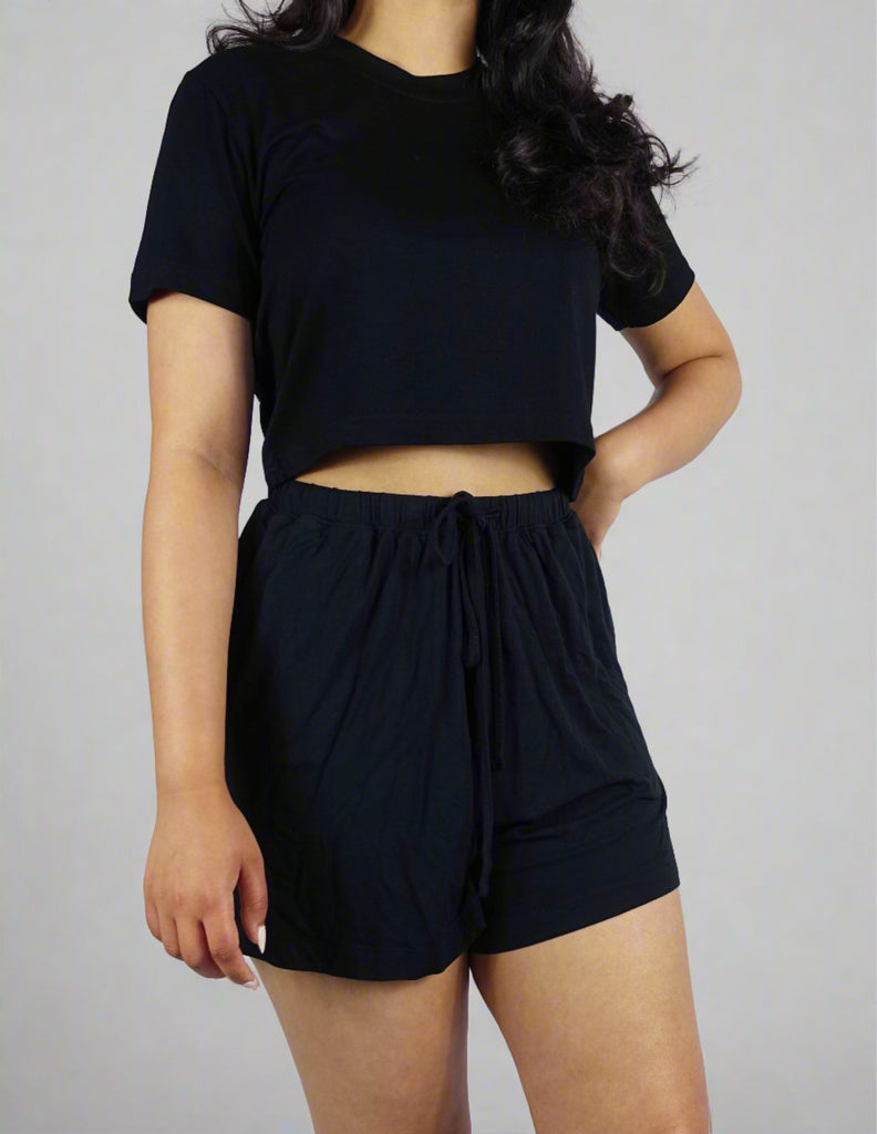 Black crop top with a casual style on a model with a white background