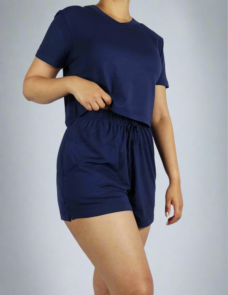 A woman wearing a navy crop tee with round neck and short sleeve