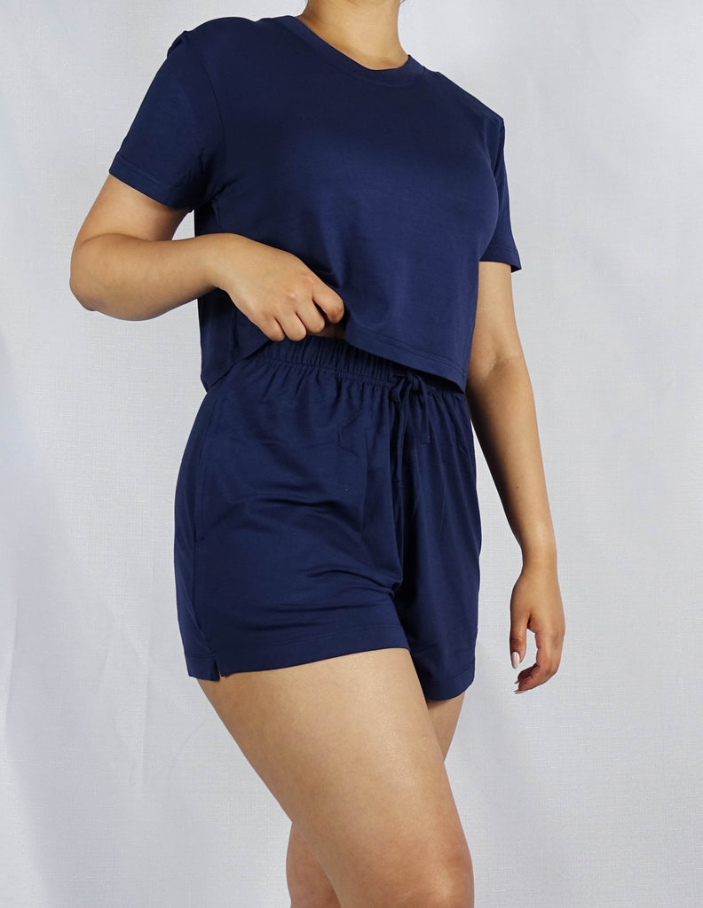 A woman wearing a navy crop tee with round neck and short sleeve