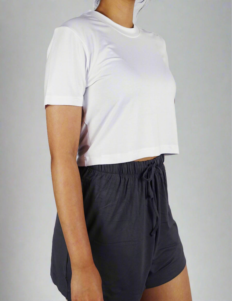 A woman wearing comfortable white crop with round neck and short sleeve top 