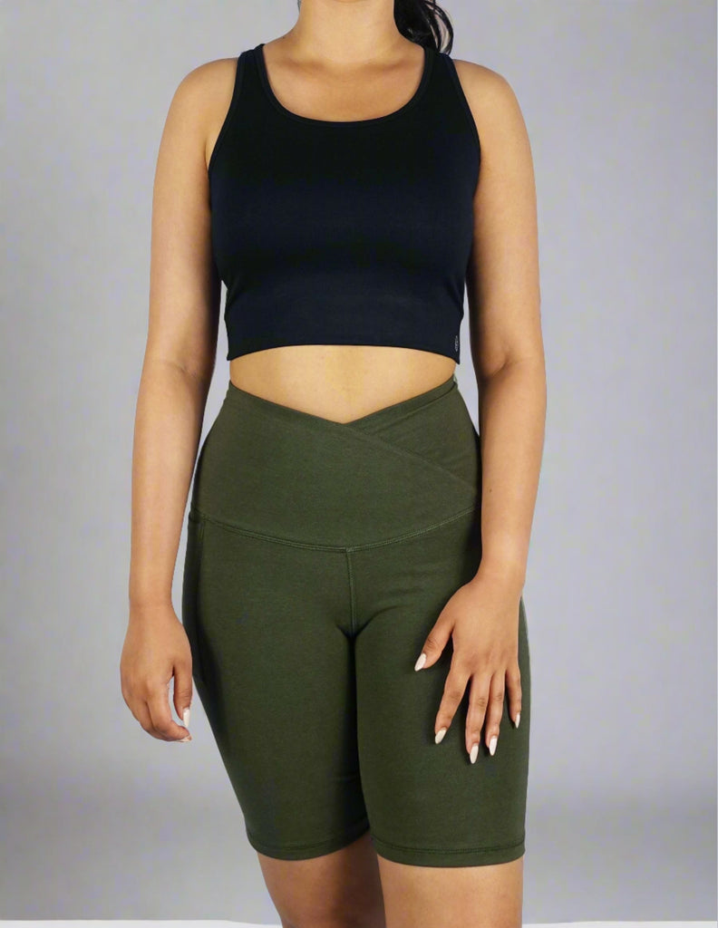 Front view of a women's black crop top with cross strap in the back