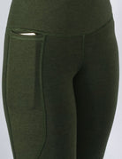 Bamboo high-waist leggings in khaki are shown in a close phone pocket view.