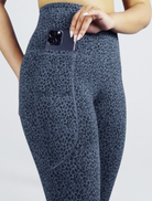 Women's Super Super Soft Bamboo Tights Leopard print leggings with a pocket holding a phone on a light gray background