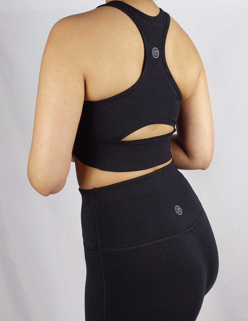 Side view of black sports bra with keyhole cut and side panel stitch for comfort