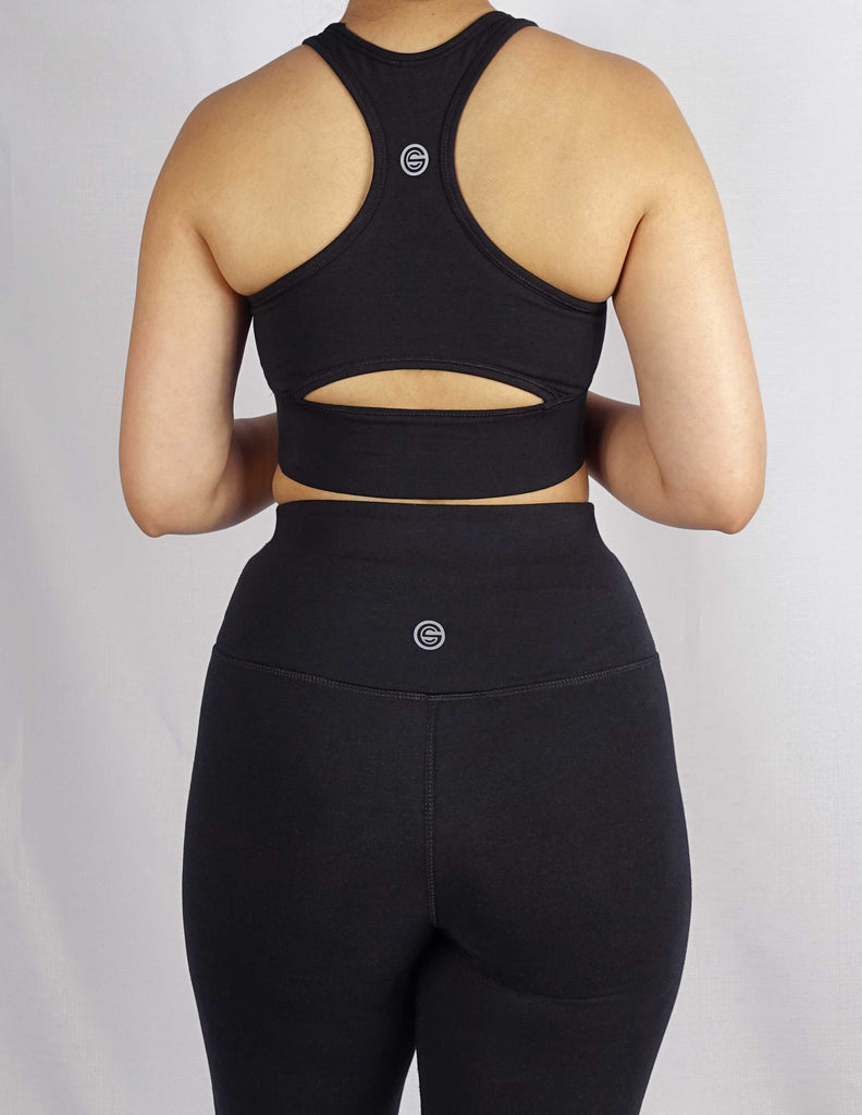 Back view of black sports bra with keyhole cut and side panel stitch for comfort