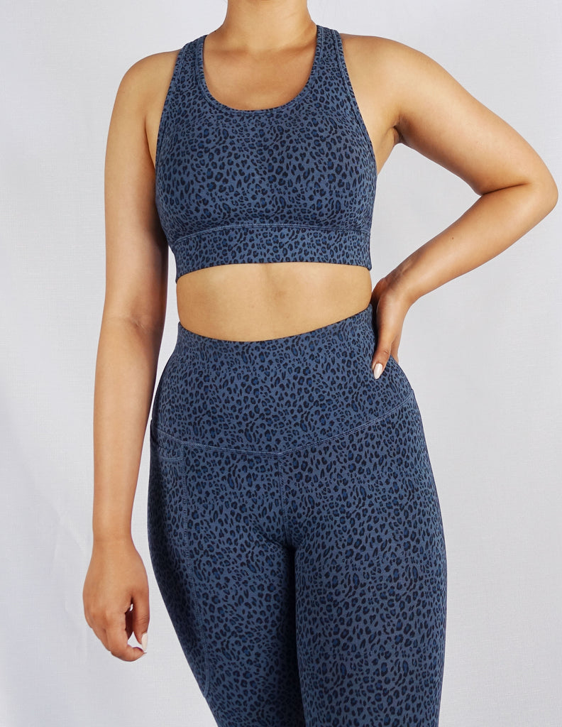 Model wearing blue leopard print sports bra