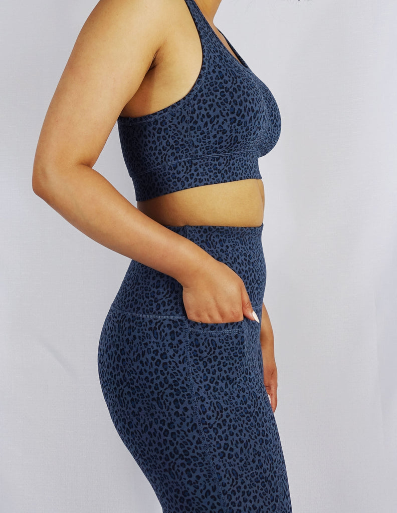 Side view of model wearing blue leopard print sports bra