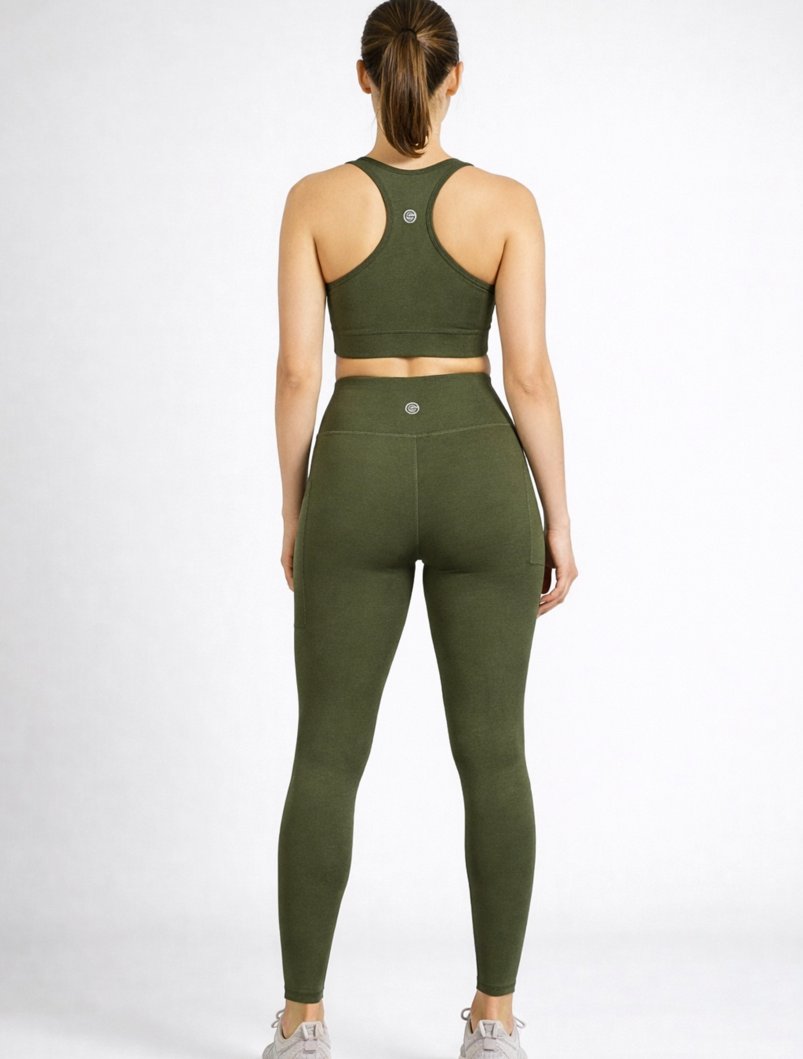 Person wearing an olive green khaki athletic outfit bamboo-athleisure-leggings and sports bra australia_activebygs on a white background
