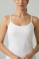 Young woman wearing bamboo camisole top singlet in white