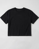 Flat lay product shot of a women's Black boxy cropped t-shirt featuring a relaxed crew neck cut and short drop sleeves on a plain light grey background