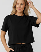 Front view studio model wearing a black boxy crop tee paired with matching black high-waisted drawstring lounge shorts