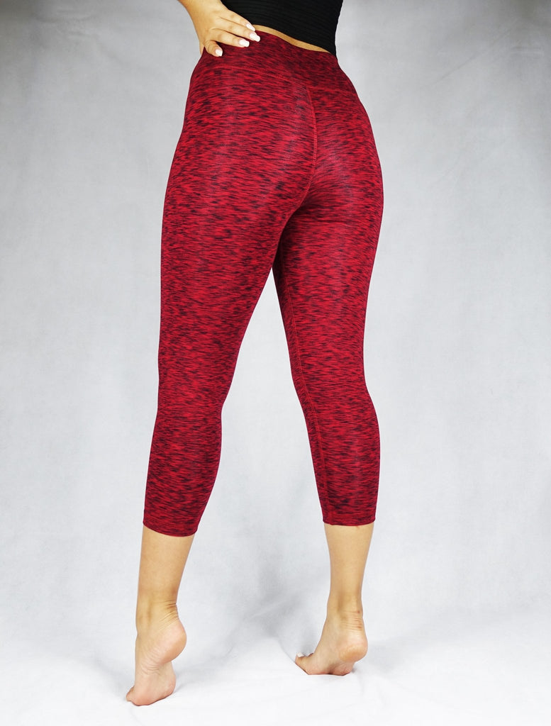 Back view of a woman wearing red crop leggings, activewear