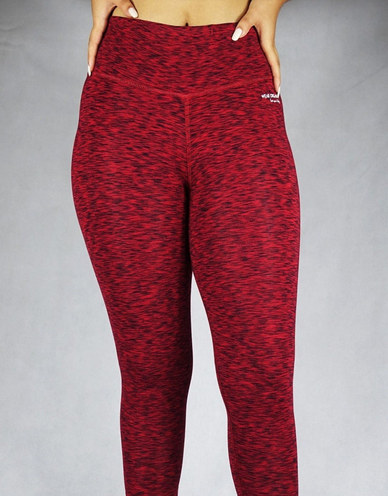 Front view of a model wearing red full length leggings, activewear