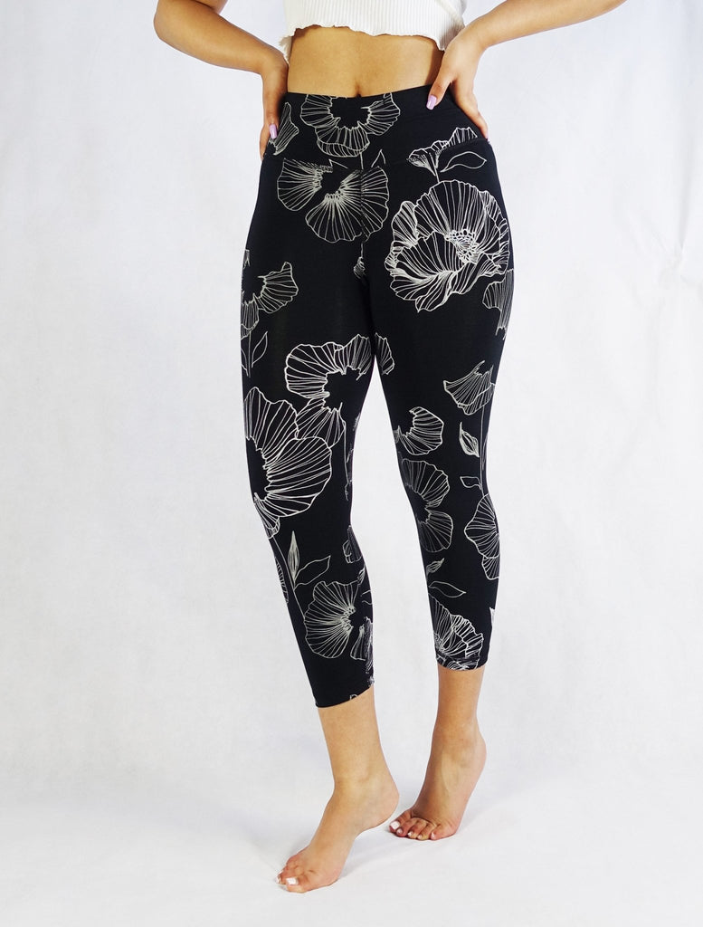 Woman wearing black floral crop leggings