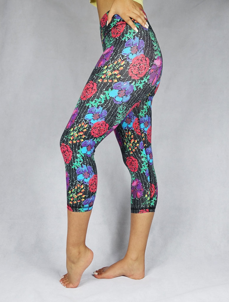 Woman wearing red, blue and green flowery prints of  crop leggings