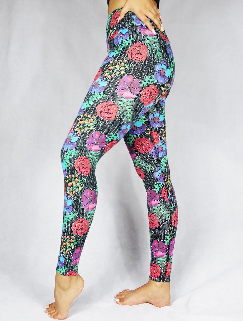 model wearing full length legging with a red, blue and green flowery prints 