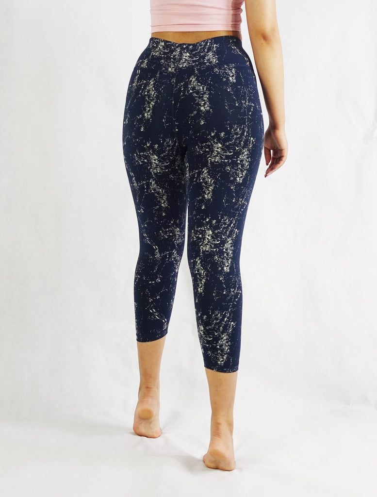 Back view of blue crop leggings with prints