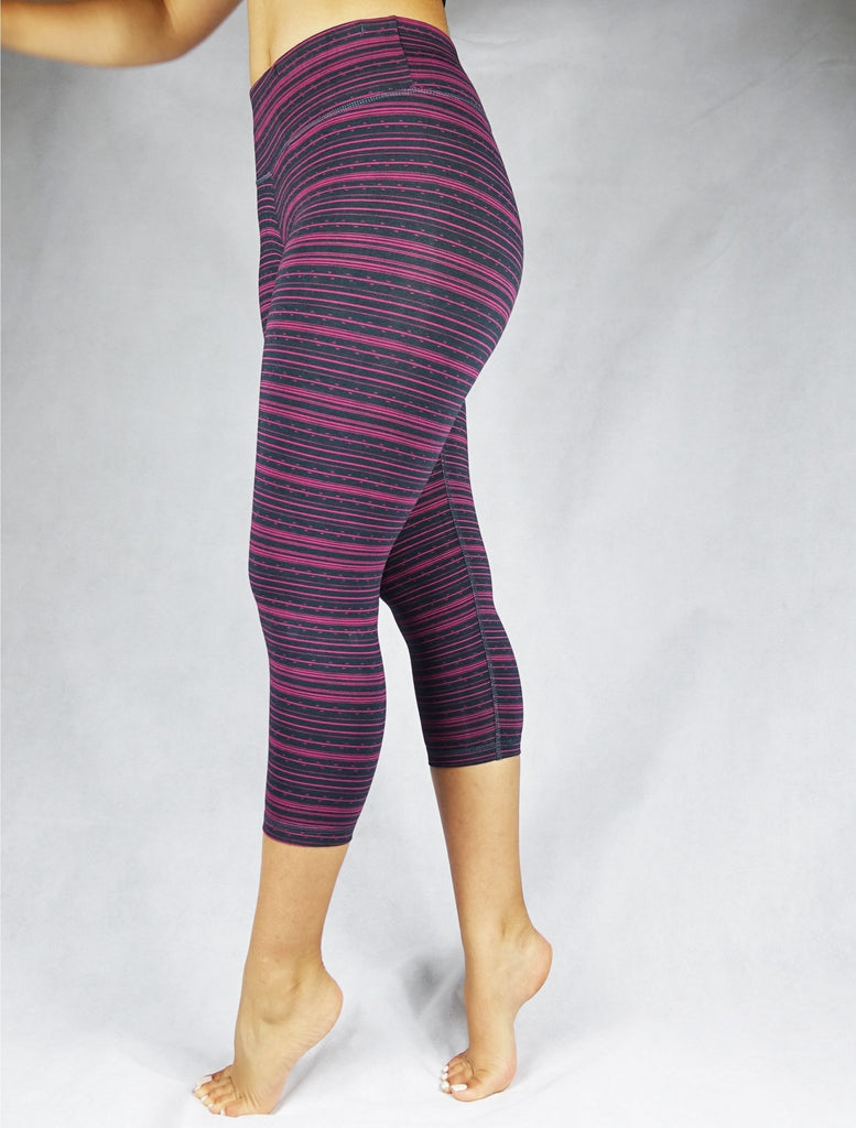 Side view of pink stripe on black crop leggings, activewear